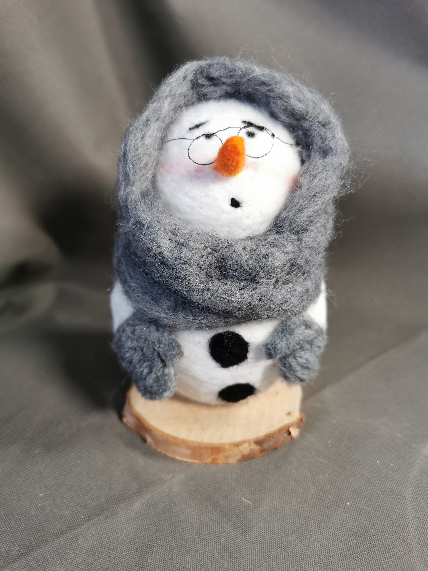 Schneemann eingehüllt in einem dicken Schal