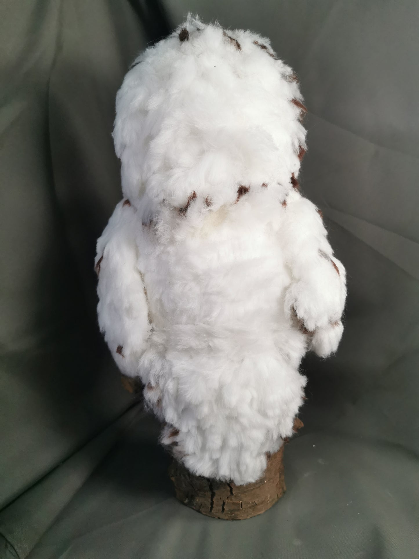 Schnee-Eule auf einem Holzklotz